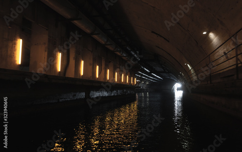 Illuminated concrete tunnel perspective,