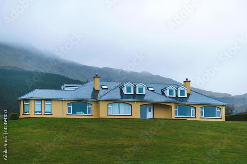 yellow house on green meadow