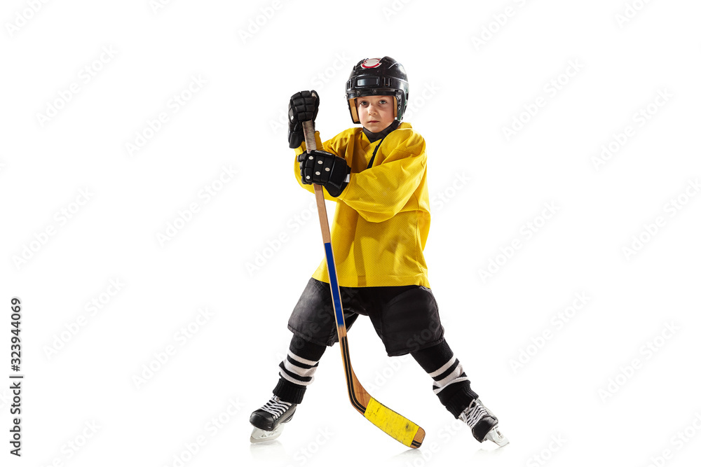 Little hockey player with the stick on ice court and white studio background. Sportsboy wearing equipment and helmet practicing, training. Concept of sport, healthy lifestyle, motion, movement, action Little hockey player with the stick on ice court and white studio background. Sportsboy wearing equipment and helmet practicing, training. Concept of sport, healthy lifestyle, motion, movement, action