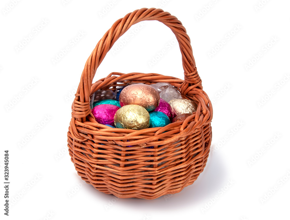 chocolate easter eggs in wooden basket isolated on the white