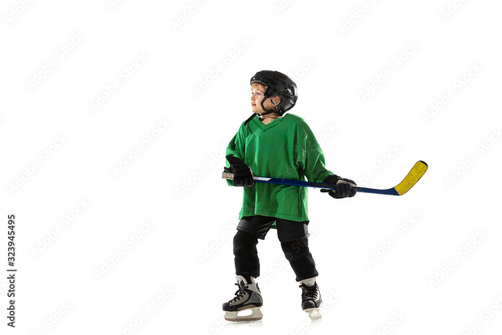 Little hockey player with the stick on ice court, white studio background. Sportsboy wearing equipment and helmet, practicing, training. Concept of sport, healthy lifestyle, motion, movement, action. Little hockey player with the stick on ice court, white studio background. Sportsboy wearing equipment and helmet, practicing, training. Concept of sport, healthy lifestyle, motion, movement, action.