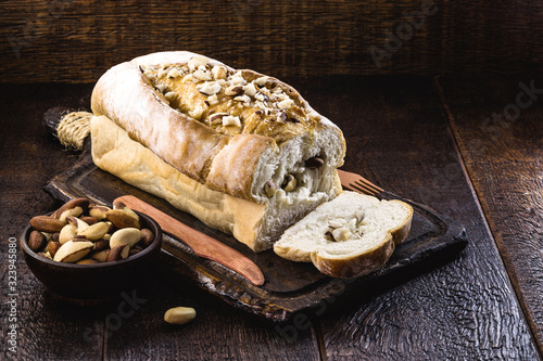 Brazil nut bread recipe. Homemade bread on wooden background based on chestnuts and wheat.Vegan bread made with Amazonian nut, Bolivian nut, Toquei or Tururi. photo