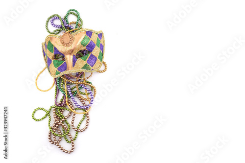 holiday or mardi gras beads and mask making frame isolated on white background photo