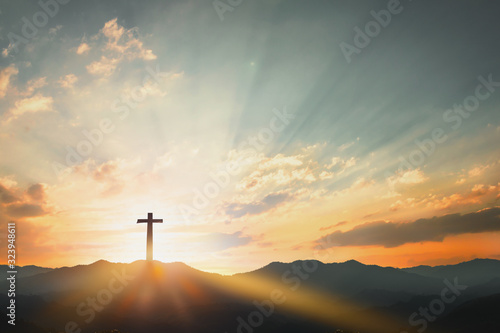 Photography Good Friday concept: cross with sunset in the sky background