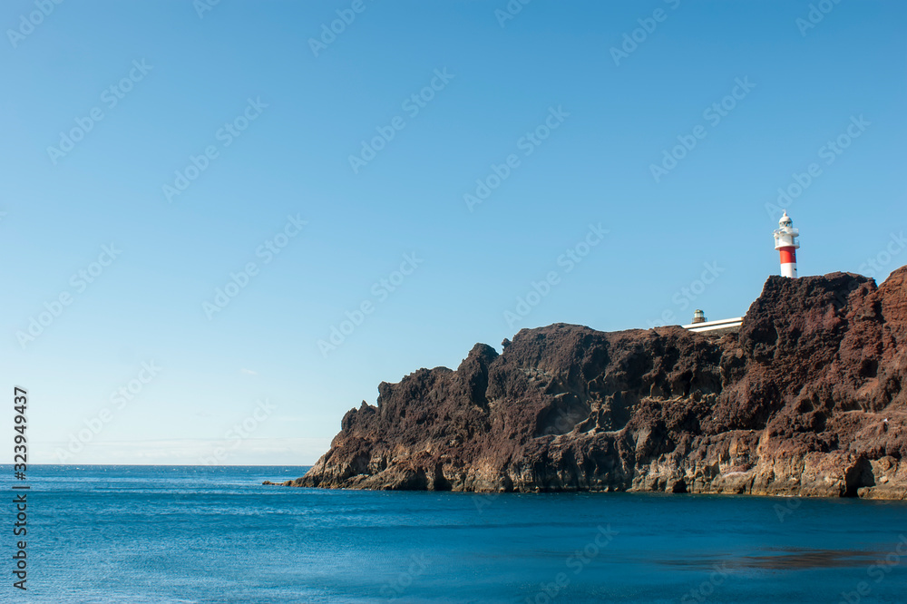 Lighthouse on Teno cape. The westernmost point of the island of Tenerife. View of the rock with a lighthouse.