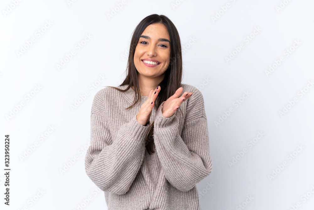 Young brunette woman over isolated white background applauding after presentation in a conference Young brunette woman over isolated white background applauding after presentation in a conference