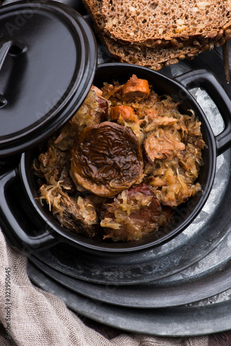 Traditional polish sauerkraut (bigos) with mushrooms and plums for christmas photo