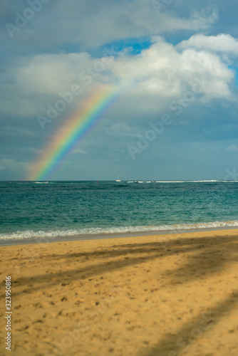 View of a Rainbow Over the Pacific Ocean from the Beach in Hawaii