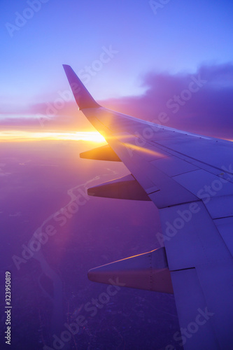 Beautiful sunset, sky on the top view, airplane flying view from inside window and cloud, sun down background aircraft of Traveling.