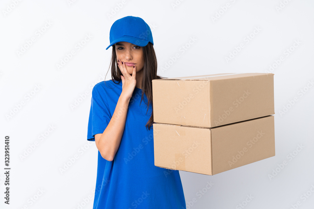 Young delivery woman over isolated white background unhappy and frustrated