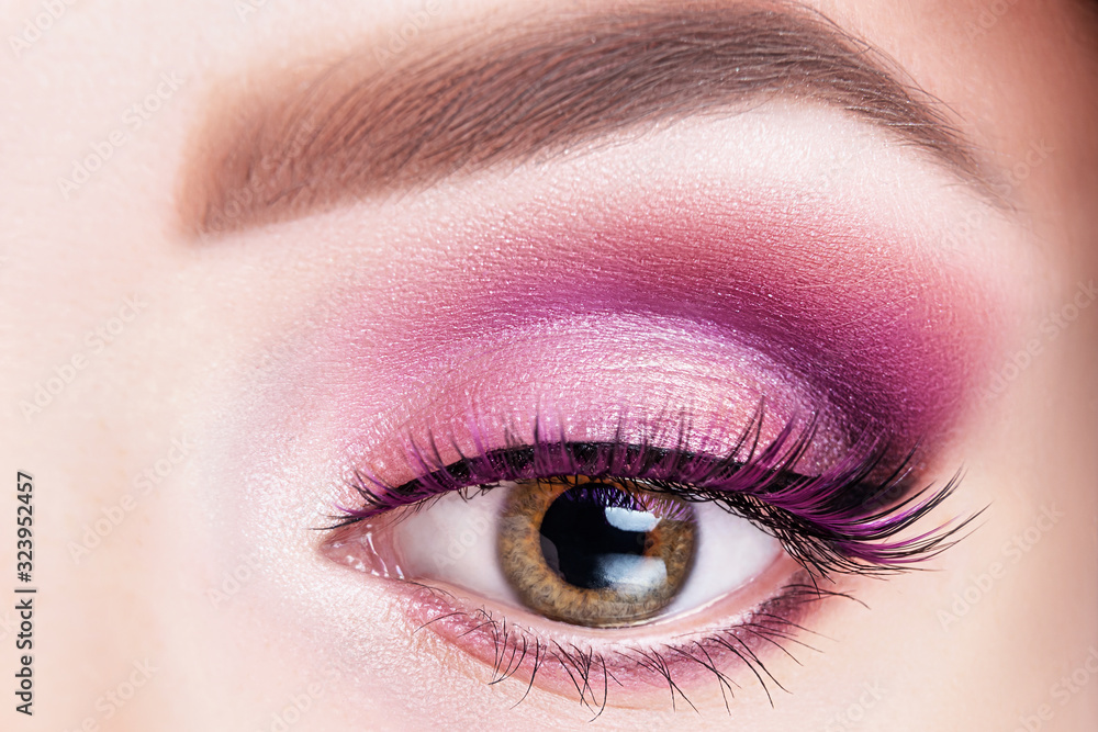 Obraz premium Fashionable bright eye makeup close-up. Female eye with violet shadows and false eyelashes