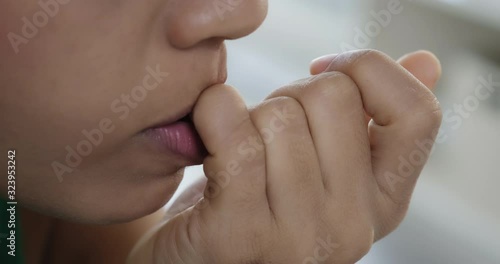 Young black businesswoman working at home. Stressed girl with anxiety in office. Closeup of teeth biting fingernails for problems