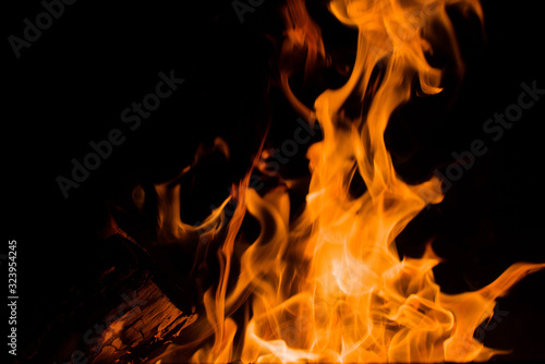 Orange flames on a black background  closeup. Texture of a fiery flame