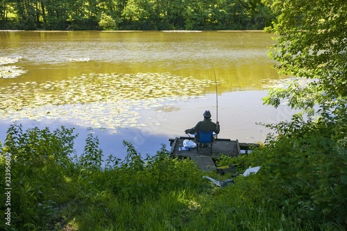 High angle shot of a person coarse fishing at a lake in Wiltshire, UK in the early morning