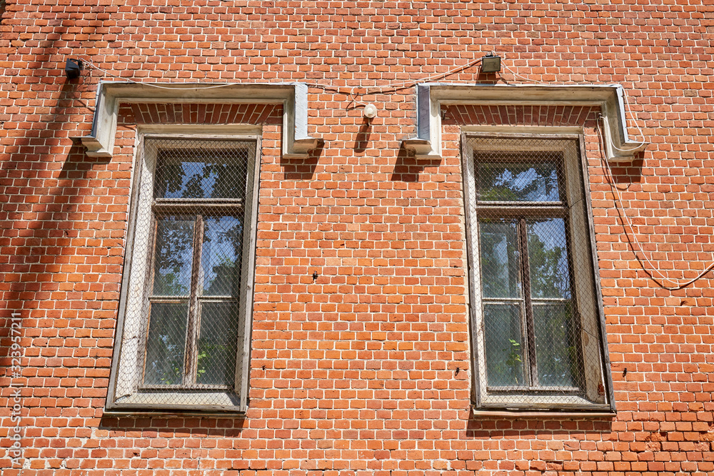 The windows of the old palace with a metal mesh for security