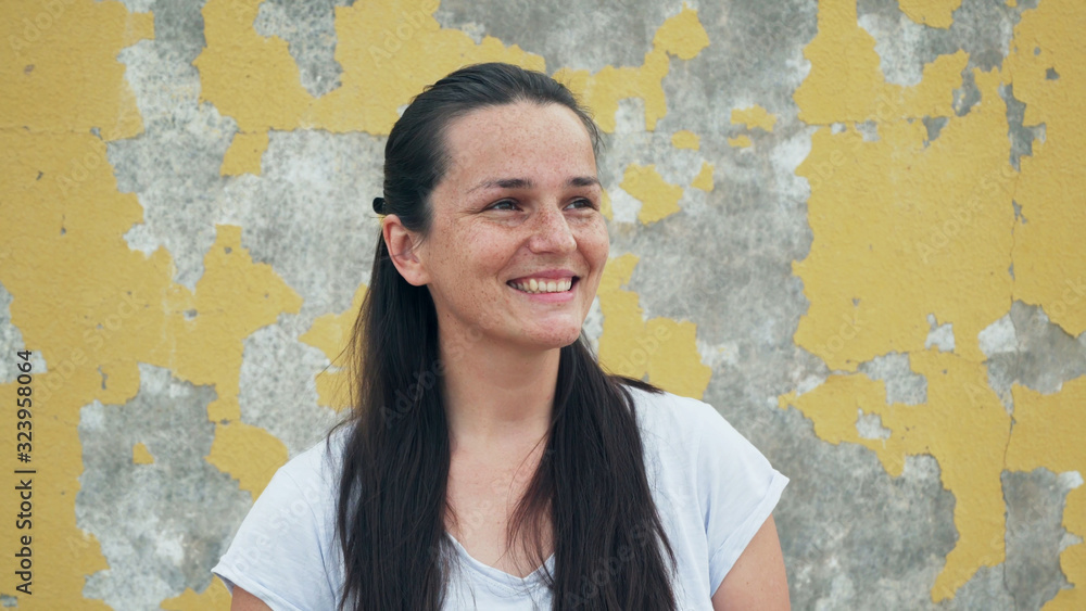 Portrait of handsome young girl with freckles making dreaminess emotion