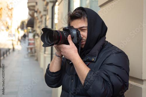 Young photographer taking photos on the streets of the city