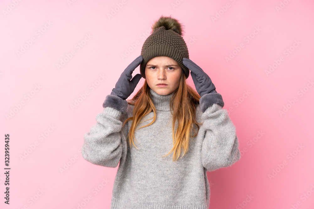 Ukrainian teenager girl with winter hat over isolated pink background unhappy and frustrated with something. Negative facial expression Ukrainian teenager girl with winter hat over isolated pink background unhappy and frustrated with something. Negative facial expression