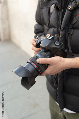 Young photographer taking photos on the streets of the city