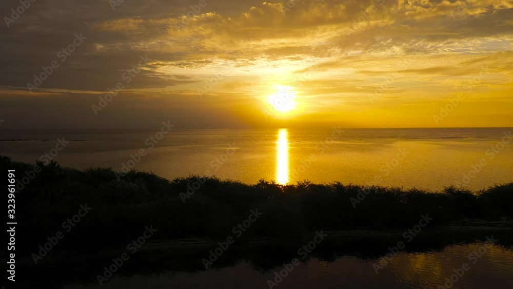Sunrise over the sea in the tropics, aerial view. Sunrise over ocean. Sunrise over the sea in the tropics, aerial view. Sunrise over ocean.
