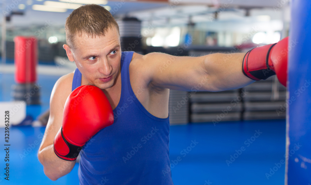 Adult male is fighting punching bag