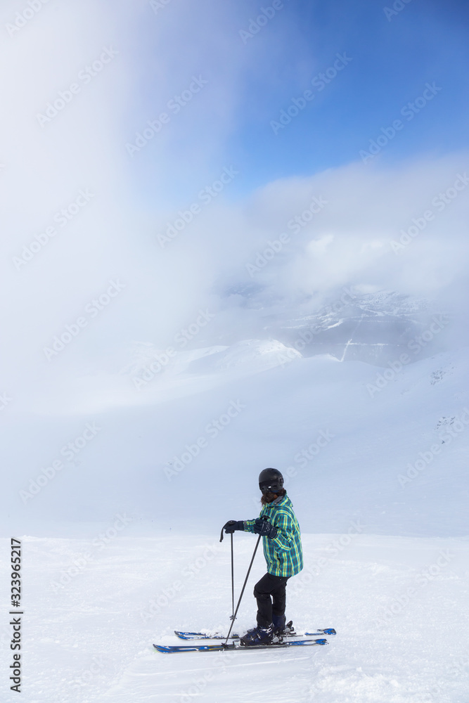 Adventurous Girl Skiing on a beautiful snowy mountain during a vibrant and sunny winter day. Taken in Whistler, British Columbia, Canada.