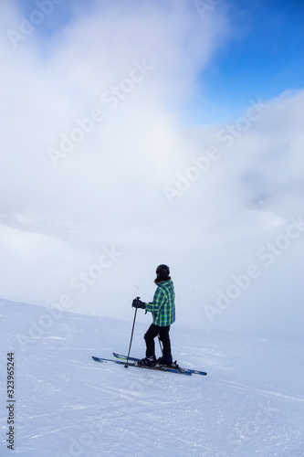 Adventurous Girl Skiing on a beautiful snowy mountain during a vibrant and sunny winter day. Taken in Whistler, British Columbia, Canada.
