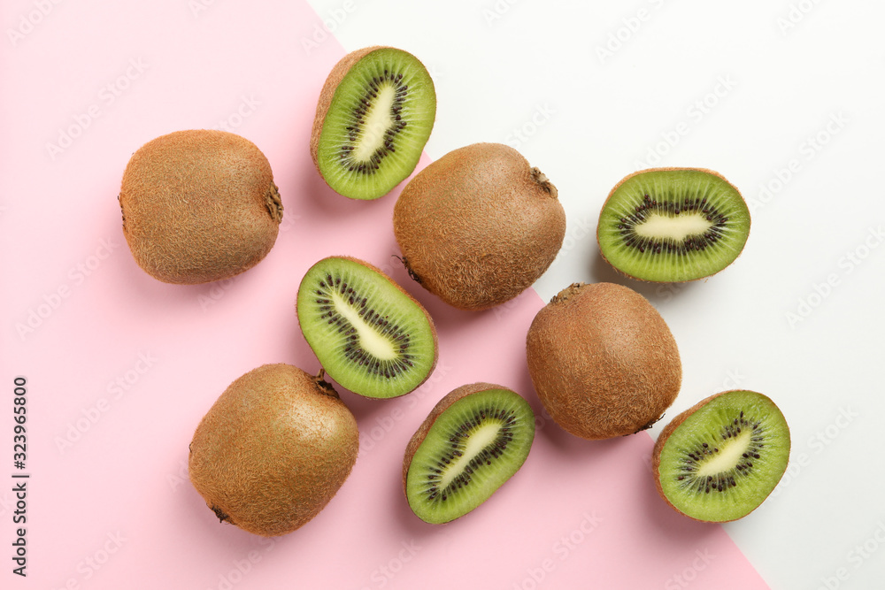 Fototapeta premium Ripe sweet kiwi on two tone background, top view