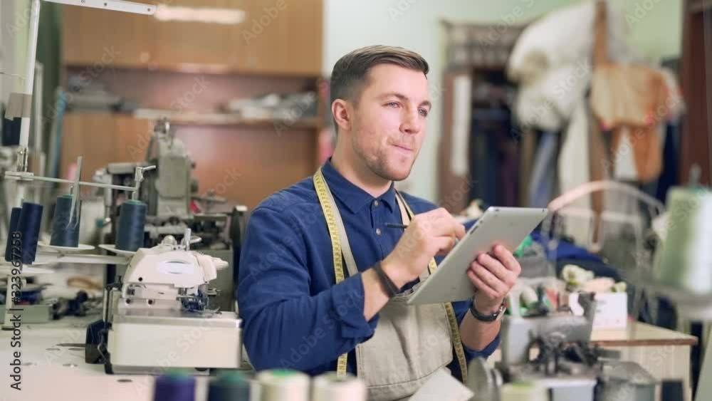 male fashion designer draws a new sketch on the tablet male fashion designer draws a new sketch on the tablet