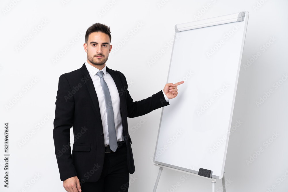 Young man giving a presentation on white board Young man giving a presentation on white board