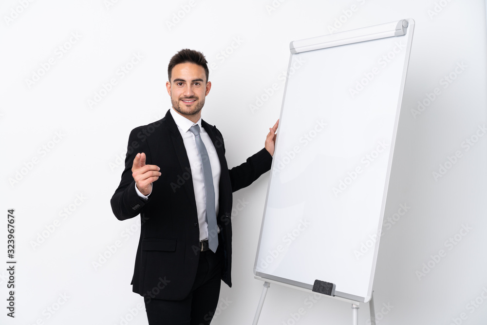 Young man giving a presentation on white board Young man giving a presentation on white board