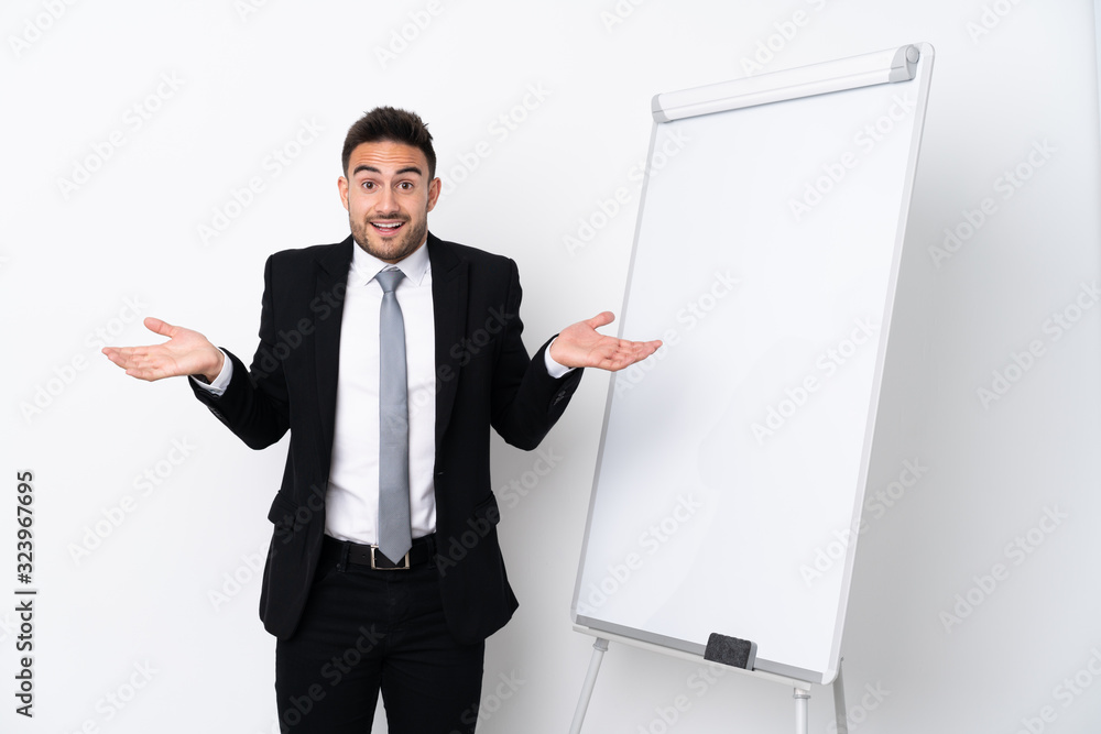 Young man giving a presentation on white board and with shocked expression Young man giving a presentation on white board and with shocked expression