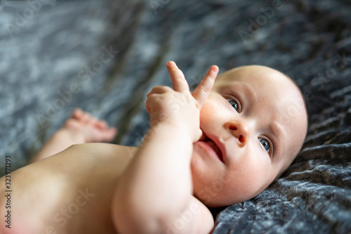 Cute blue-eyed baby boy exploring his fingers - two fingers. Learning since babyhood. Triptych.