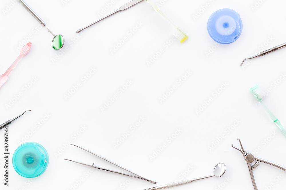 Dental care concept. Stomatological tools frame - with floss - on white background top-down frame copy space Dental care concept. Stomatological tools frame - with floss - on white background top-down frame copy space
