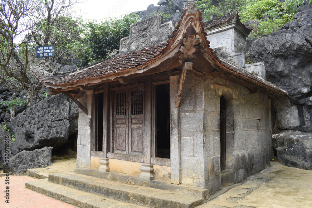 Outdoor park landscape with lake and stone bridge. Gate entrance to ancient Bich Dong pagoda complex. Ninh Binh, Vietnam Outdoor park landscape with lake and stone bridge. Gate entrance to ancient Bich Dong pagoda complex. Ninh Binh, Vietnam