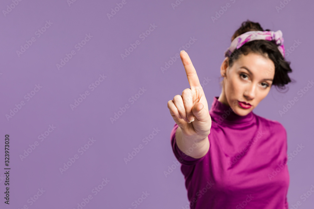 Woman holding a finger up and copy space Woman holding a finger up and copy space