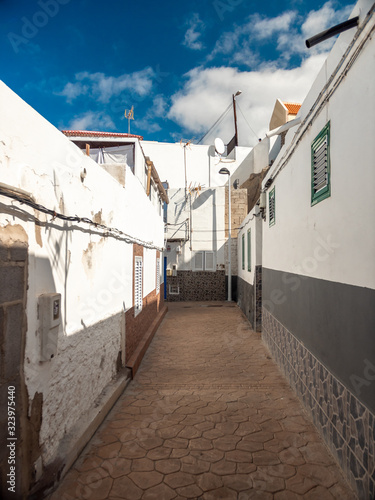 Beautiful image of narrow street of small seaide town in Greece photo