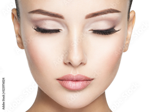 Beautiful and calm face of young woman with  health skin
