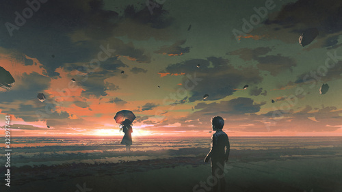 Fotografie a boy looking at the mysterious woman with umbrella standing in the sea against