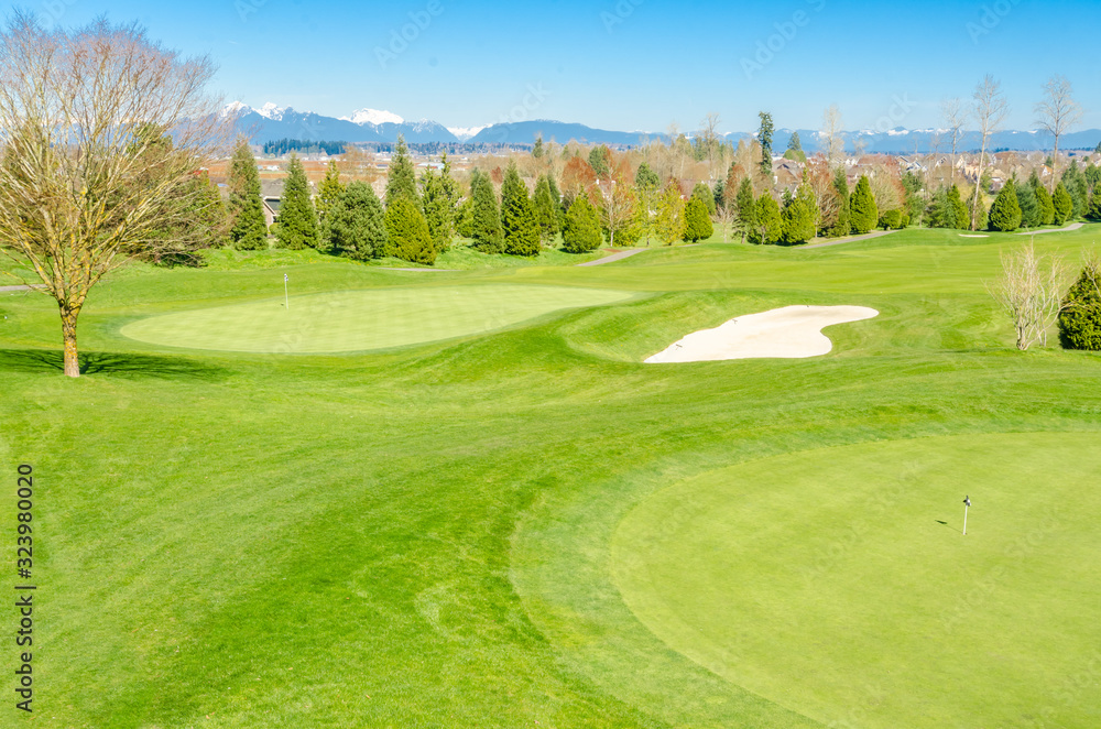 Golf course with gorgeous green and pond.