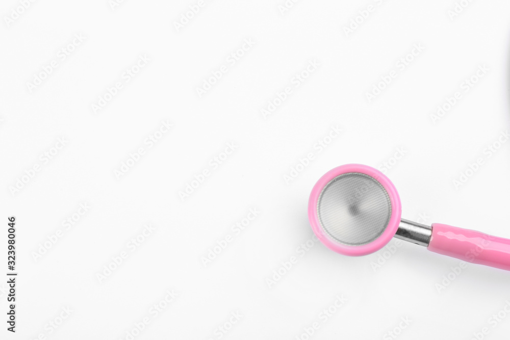 Pink stethoscope isolated on white, top view. Breast cancer awareness Pink stethoscope isolated on white, top view. Breast cancer awareness