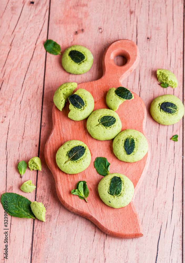 Shortbread cookies with mint, fragrant mint and sprigs of demen sedated on a wooden background. Tasty food