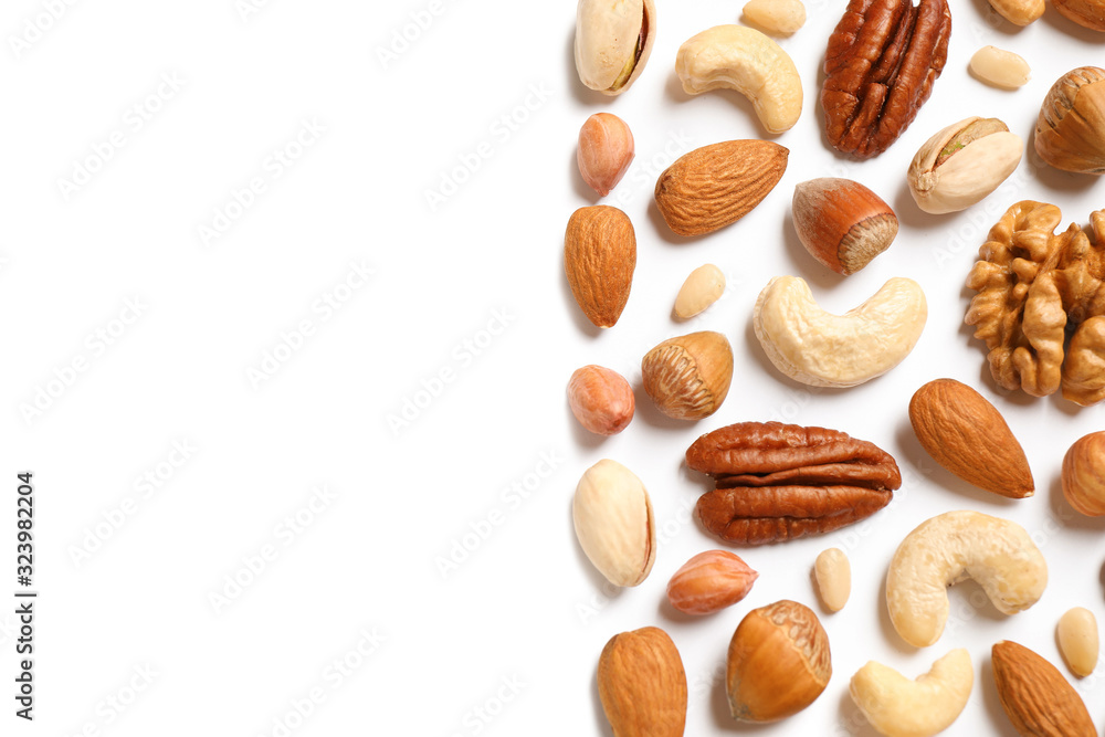 Different delicious nuts on white background, flat lay. Space for text Different delicious nuts on white background, flat lay. Space for text