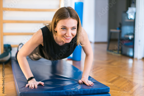 Obraz na plátně young woman exercising at the gym