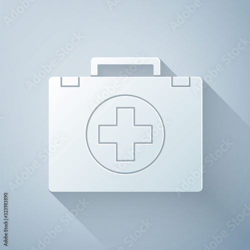 Paper cut First aid kit icon isolated on grey background. Medical box with cross. Medical equipment for emergency. Healthcare concept. Paper art style. Vector Illustration