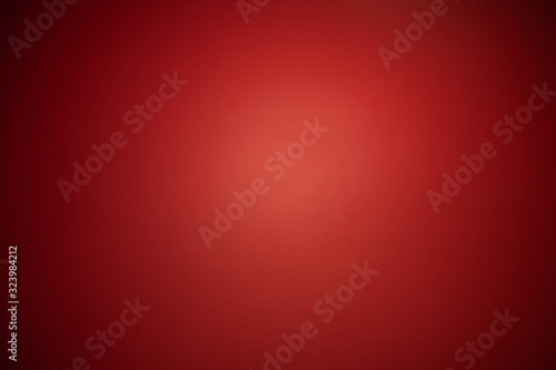 Abstract red spotlight background with dark vignettes.