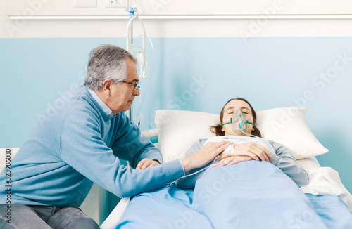 Father assisting her sick daughter at the hospital