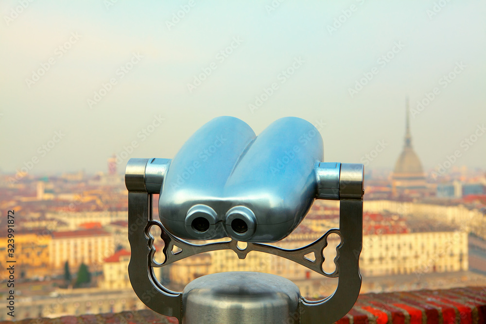 Looking at Turin city through tourist binoculars