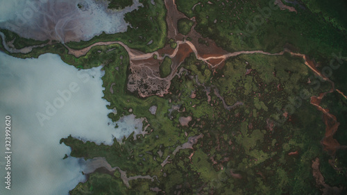Aerial view river flows into a lake in Highlands of Iceland. Beautiful green patterns all over Iceland.