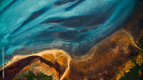 Aerial view from above on a green and blue glacier river stream in  South Iceland. Beautiful patterns, textures and structures. Melting glacier,  Global warming and climate change concept © eVEN